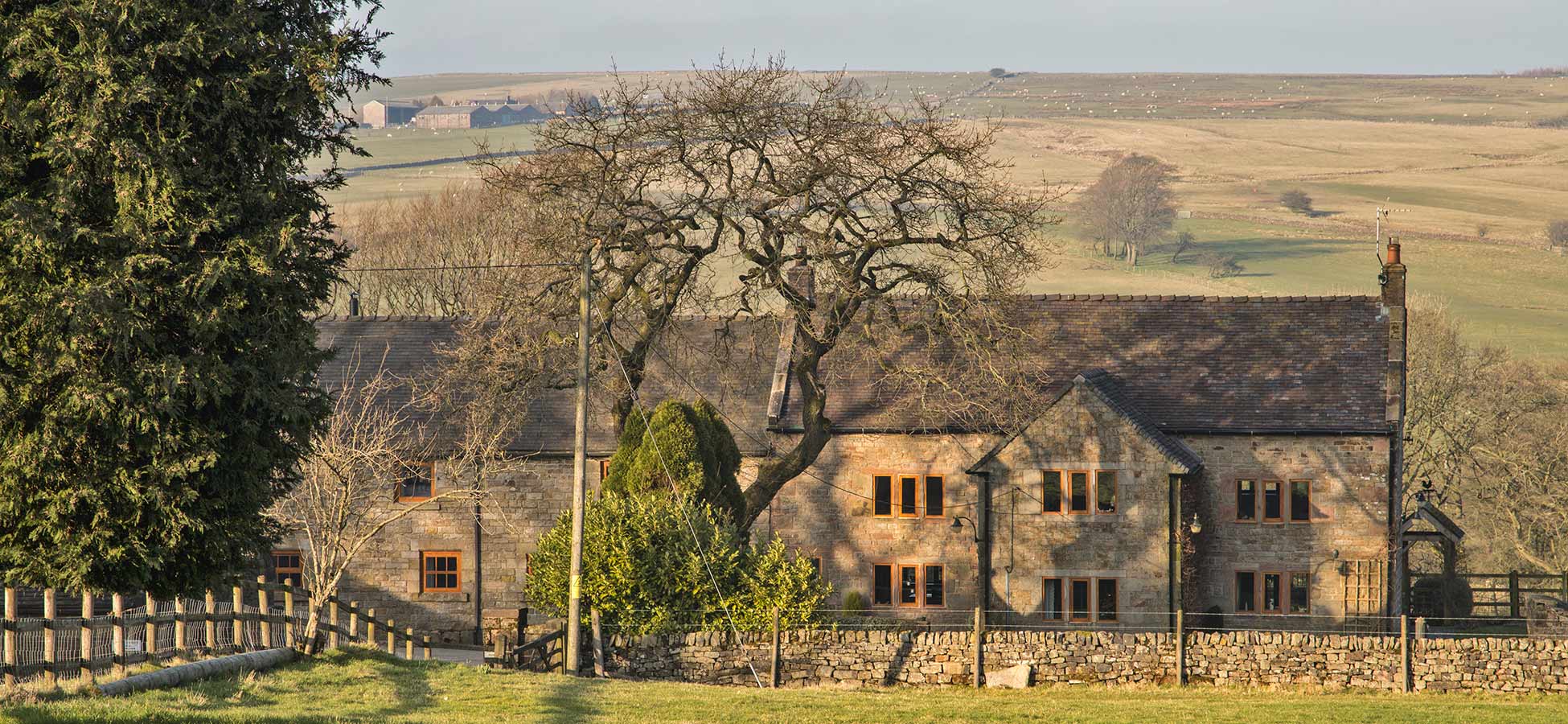 A stone farmhouse behind a dry-stone wall in the Staffordshire Moorlands