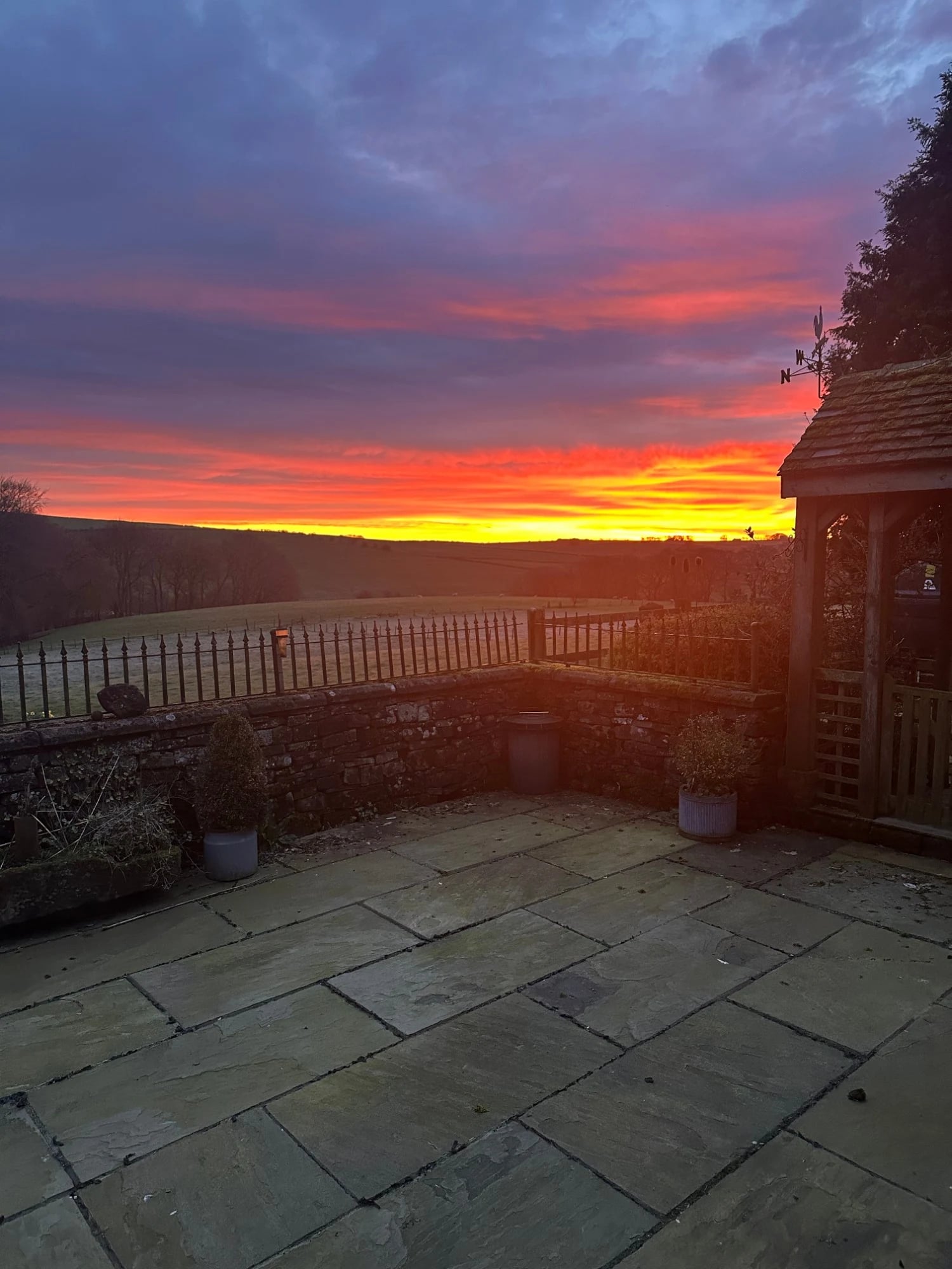 Sunset over open farmland, seen from the patio at Lane Head